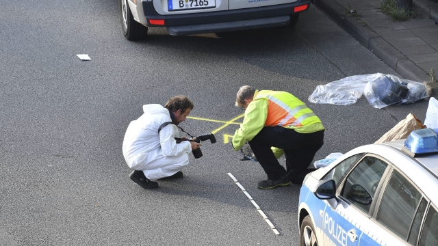 Investigators work on the scene following several accidents on the city motorway A100 in Berlin, Germany.