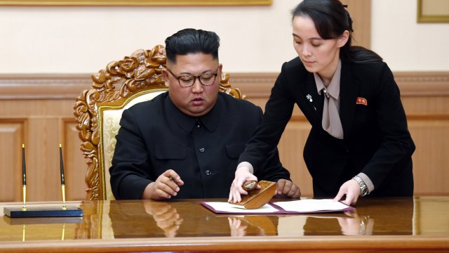 Kim Yo Jong, right, helps her brother North Korean leader Kim Jong Un sign a statement