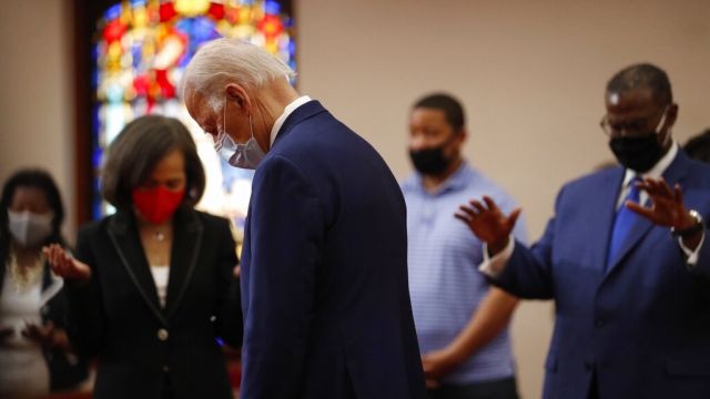Former Vice President Joe Biden bows his head in prayer during a visit to Bethel AME Church
