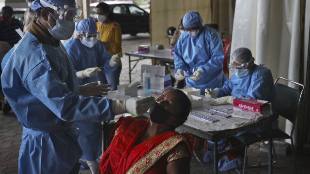 Health workers conduct rapid antigen tests in New Dehli, India, which have yielded less accurate results.