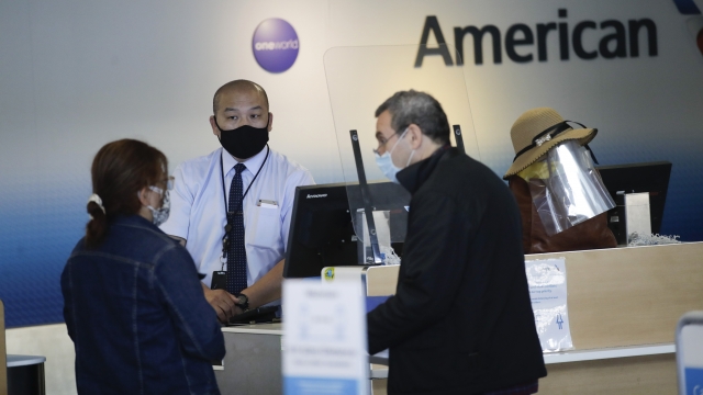 Travelers check in at the American Airlines terminal at the Los Angeles International Airport