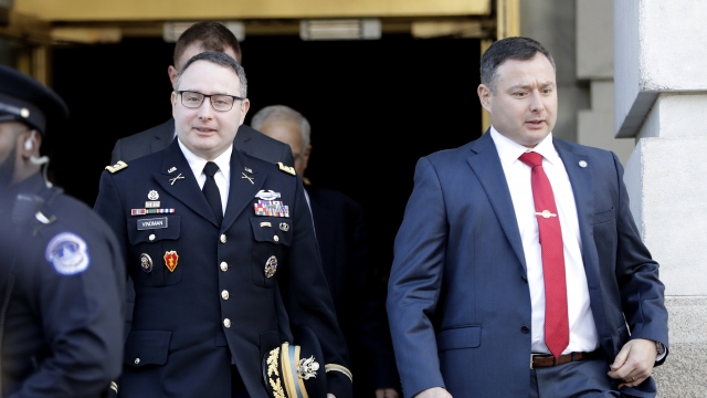 National Security Council aide Lt. Col. Alexander Vindman, left, walks with his twin brother, Army Lt. Col. Yevgeny Vindman.