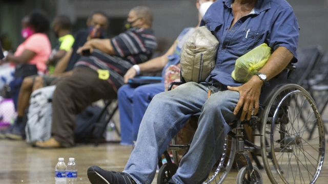 Louisiana residents wait to be evacuated to a shelter.