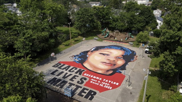 A ground mural depicting a portrait of Breonna Taylor.