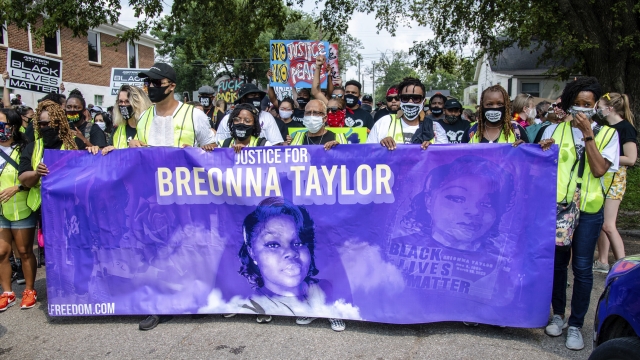 Demonstrators holding a banner for Breonna Taylor