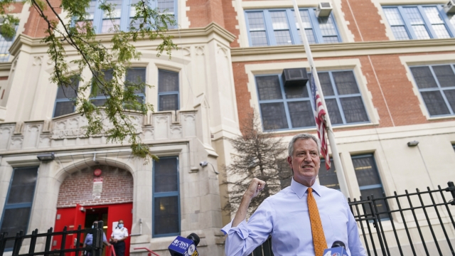 New York Mayor Bill de Blasio speaks to reporters after visiting New Bridges Elementary School.