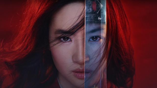 Disney character Mulan holds sword up to face.