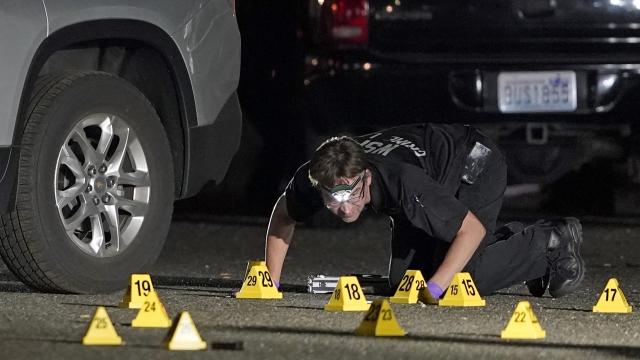 A Washington State Patrol Crime Lab worker looks at evidence markers in the early morning hours of Friday, Sept. 4, 2020