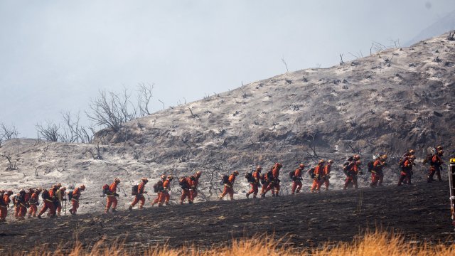 Members of a hand crew work on a California fire Saturday.