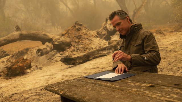 California Gov. Gavin Newsom signs Assembly Bill 2147 after touring a fire zone.