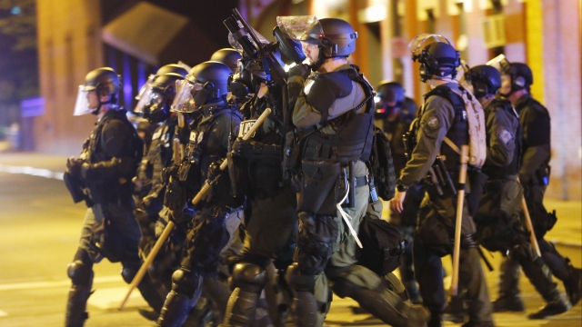 Police in riot gear attempt to clear protesters in Richmond, VA.