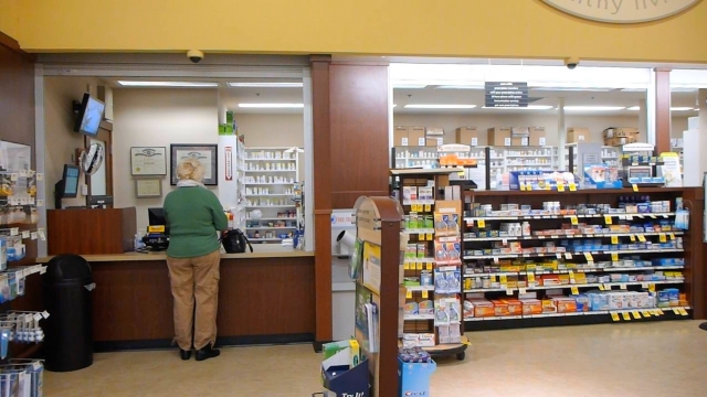 Woman standing at pharmacy counter