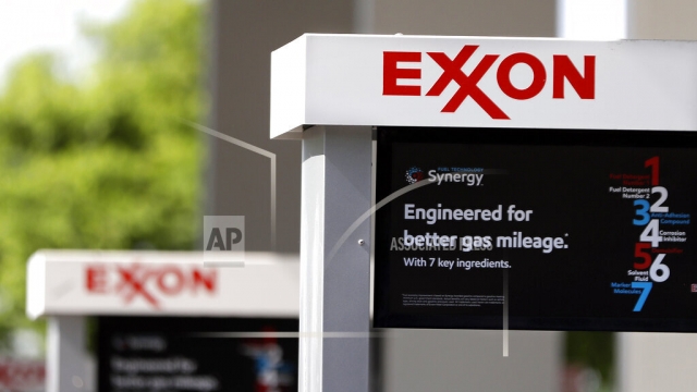 This April 25, 2017, file photo, shows Exxon service station signs in Nashville, Tenn. Exxon Mobil Corp.