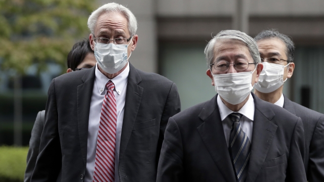 Greg Kelly, left, arrives for the first trial hearing at the Tokyo District Court in Tokyo Tuesday, Sept. 15, 2020.