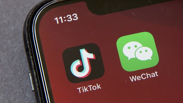A smartphone displays the TikTok app on its home screen