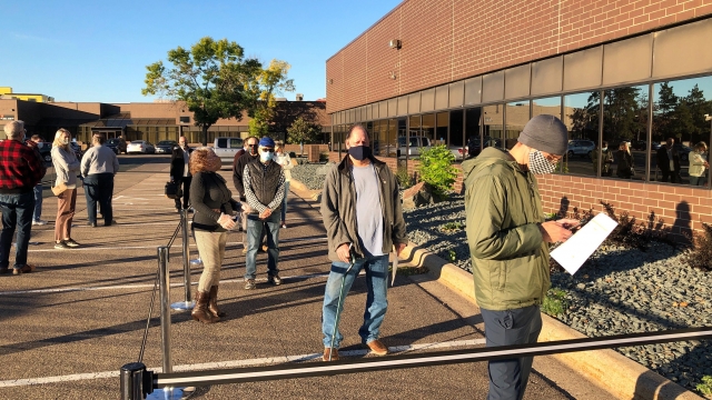 Voters line up outside of the Minneapolis early voting center