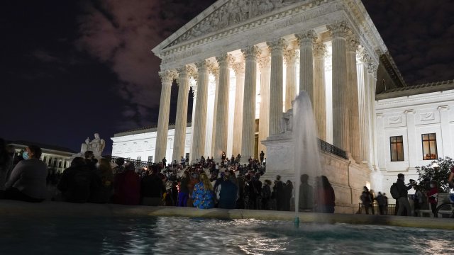 People gather at the Supreme Court Friday, Sept. 18, 2020, in Washington, after the Supreme Court.