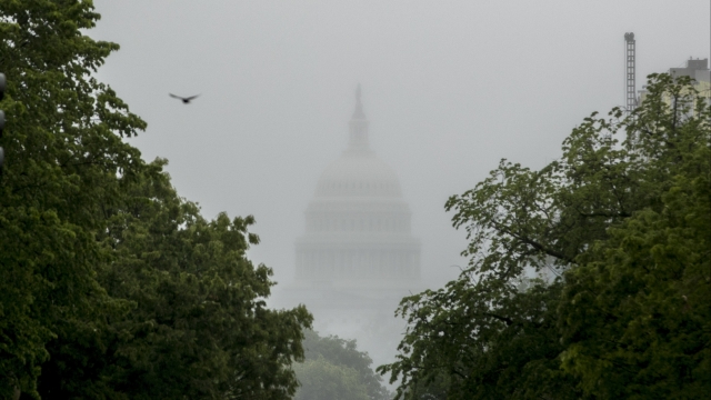 U.S. Capitol Building is barely visible through D.C. fog