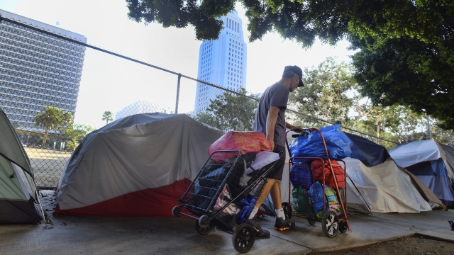 A homeless man walks through downtown Los Angeles