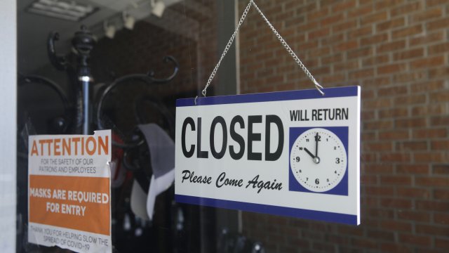 A closed sign hangs in a barber shop.