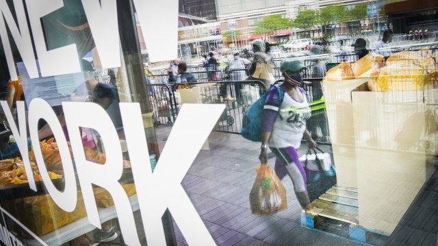 Pedestrians collect fresh produce and shelf-stable pantry items outside Barclays Center.