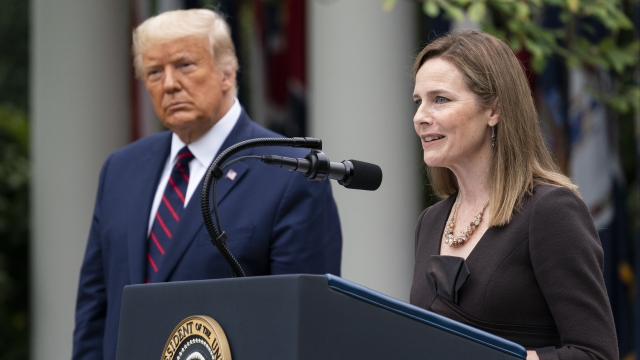 President Trump and Supreme Court nominee Judge Amy Coney Barrett stand in the Rose GArden