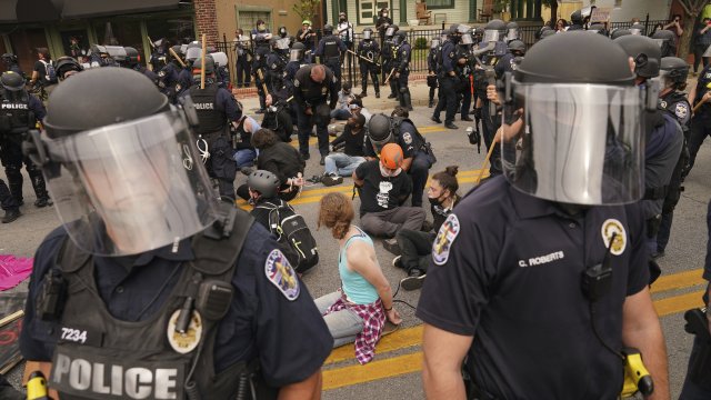 Police detain protesters, Wednesday, Sept. 23, 2020, in Louisville, Ky.