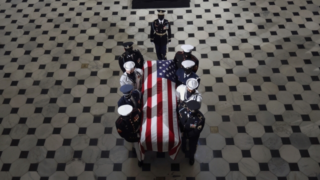 The flag-draped casket of Justice Ruth Bader Ginsburg is carried out of the Statuary Hall