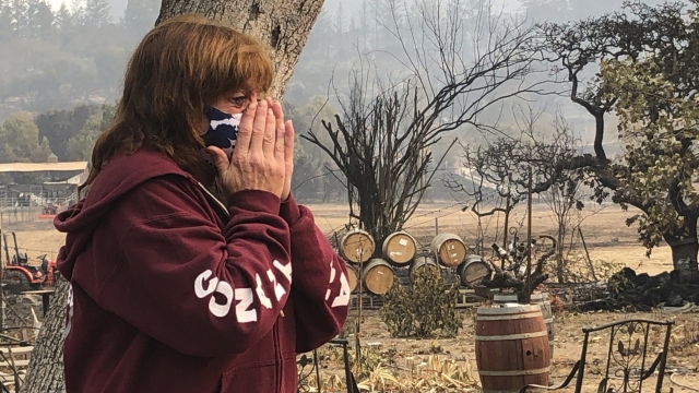 Nikki Conant cries as she looks at the debris of her home and business after the Glass/Shady fire completely engulfed it,