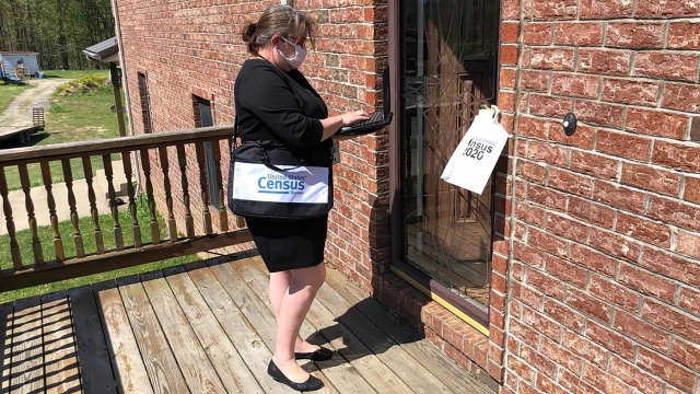 A Census Bureau staff member goes door-to-door
