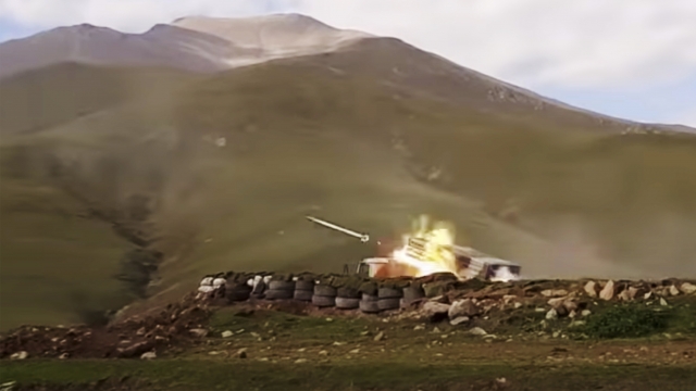 An Azerbaijan's army's multiple rocket launcher fires during fighting with Armenian forces