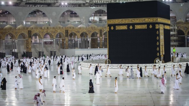 Muslims practice social distancing while praying around the Kaaba