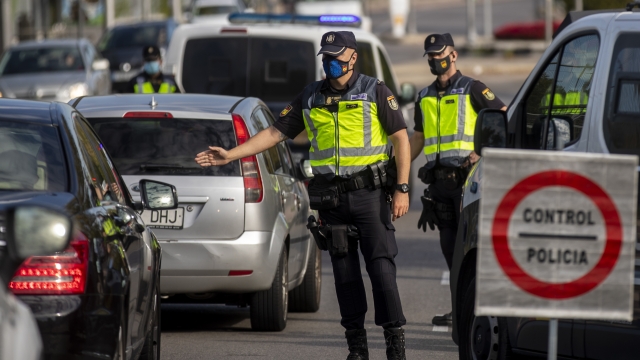 Police officers stop a car at a checkpoint in Madrid on Tuesday, Sept. 29.
