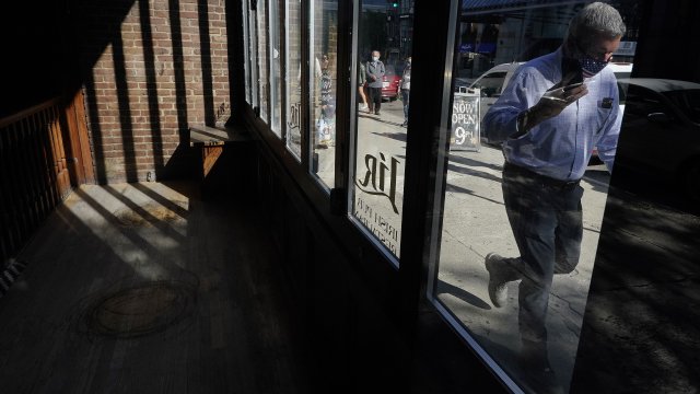 A man walks by an empty restaurant.