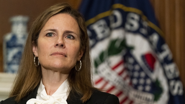 Judge Amy Coney Barrett listens during a meeting on Capitol Hill.