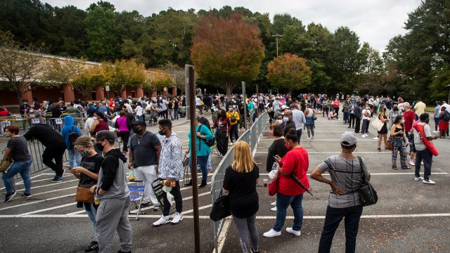 Hundreds of people wait in line for early voting on Monday, Oct. 12, 2020, in Marietta, Georgia.