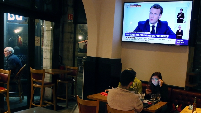 People dine at a restaurant as France's President Emmanuel Macron gives an address on television on Wednesday, Oct. 14, 2020.