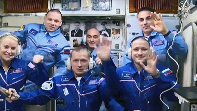 Expedition 64 crew members inside the space station’s Zvezda service module.