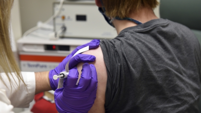 The first patient enrolled in Pfizer's COVID-19 vaccine clinical trial gets a shot.