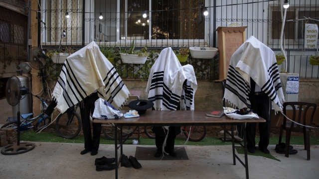 Ultra-Orthodox Jews pray covered in prayer shawls in divided sections which allow a maximum of twenty worshipers.