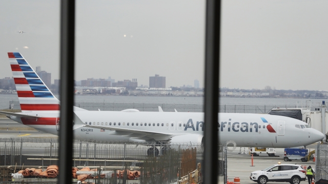 An American Airlines Boeing 737 MAX 8 plane sits at a boarding gate at LaGuardia Airport.