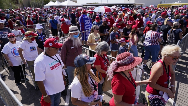Supporters of President Donald Trump wait in line to attend a campaign rally Monday, Oct. 19, 2020, in Tucson, Arizona.