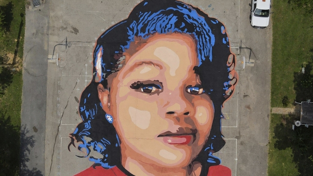 A ground mural depicting a portrait of Breonna Taylor