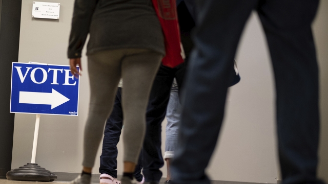 People wait in line to vote inside the DeKalb County elections office in Decatur on Monday morning October 12, 2020.