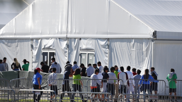 Children line up to enter a tent at the Homestead Temporary Shelter for Unaccompanied Children in Homestead, Fla. in 2019.