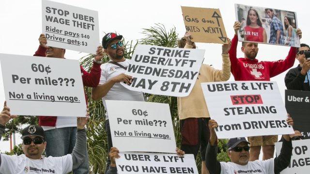 Drivers for ride-hailing giants Uber and Lyft hold a rally.