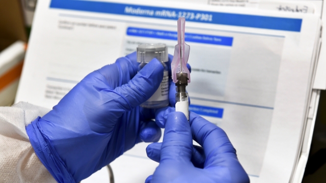 A nurse prepares a shot that is part of a possible COVID-19 vaccine, developed by the NIH and Moderna