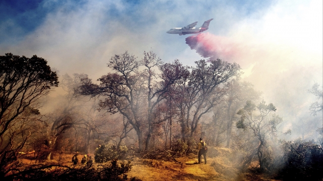 An air tanker drops retardant on the Olinda Fire burning in Anderson, Calif., Sunday, Oct. 25, 2020