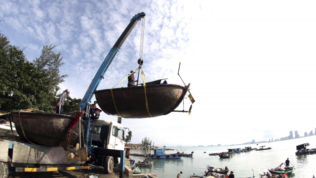 People move fishing boats to save place ahead of Typhoon Molave in Danang, Vietnam