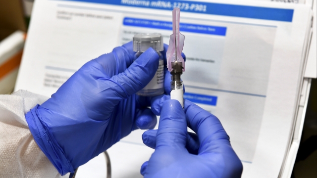 Nurse prepares a shot as part of COVID-19 vaccine trials in July.